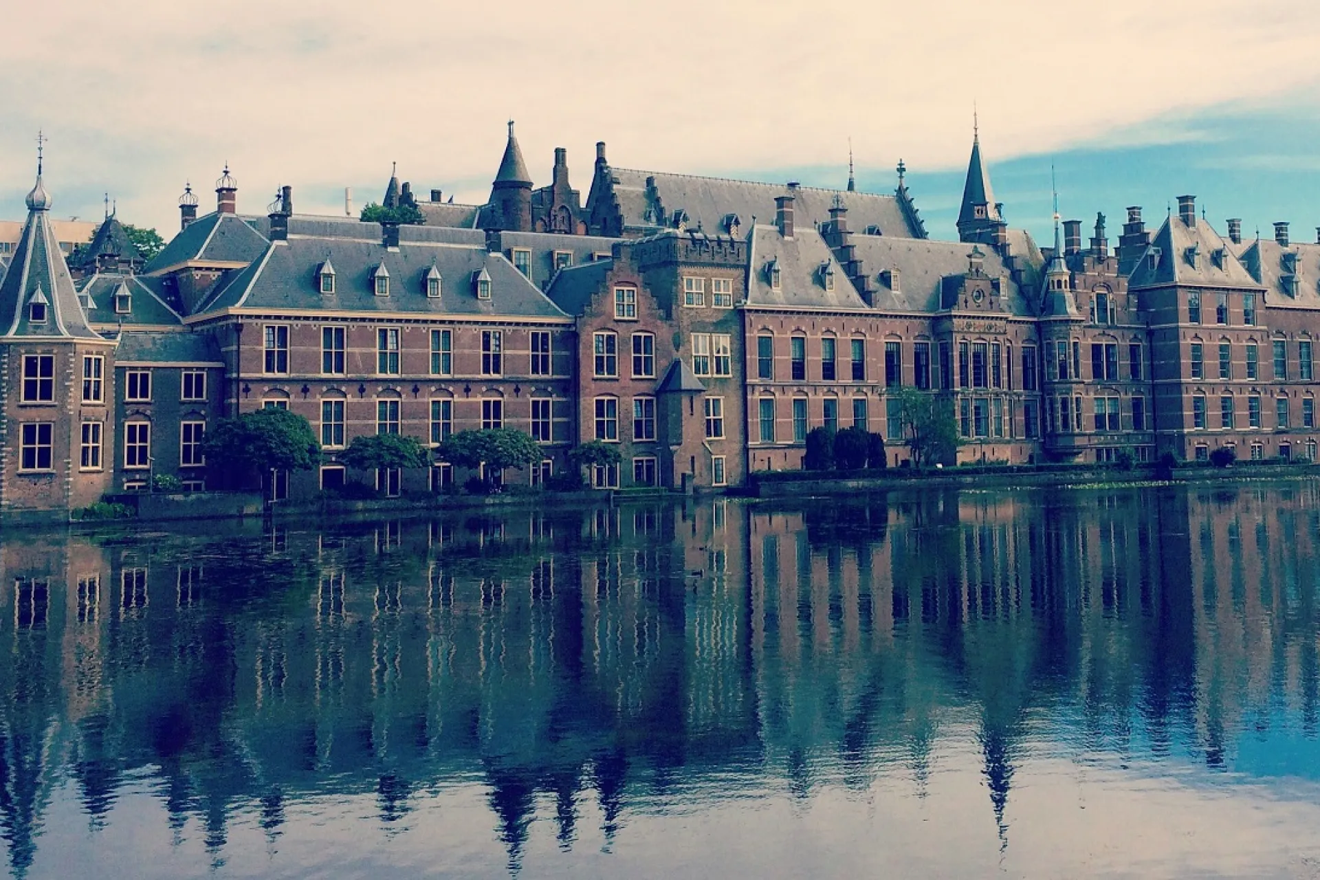Historische gebouwen van het Binnenhof die weerspiegelen in de vijver